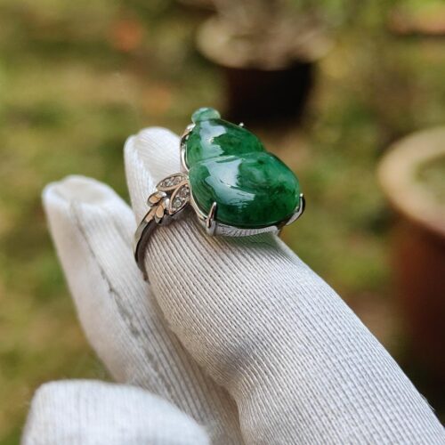 a hand wearing a gloved finger with a ring
