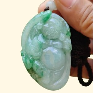 Una mano sosteniendo un colgante de jade.