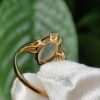 a gold ring with a stone in it