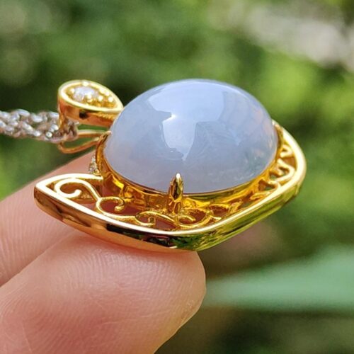 a person holding a necklace