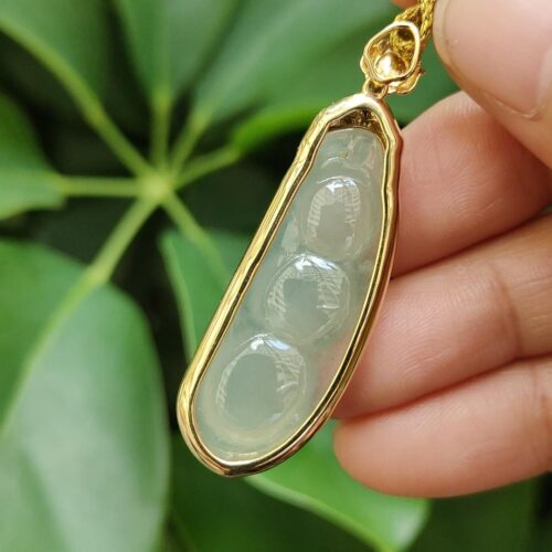 a hand holding a necklace