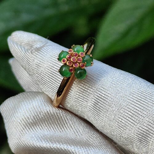 a hand wearing a glove with a ring on it