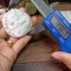 a person measuring a piece of jewelry