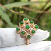 a ring with green stones on it
