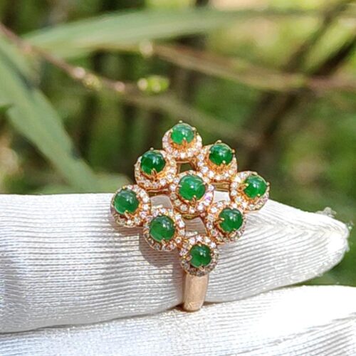 a ring with green stones on it