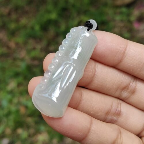 a hand holding a white object