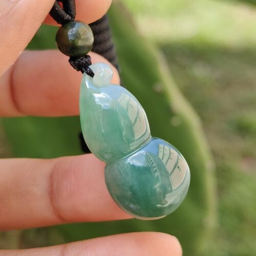 a hand holding a necklace