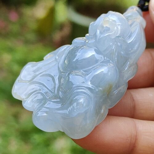 a hand holding a blue jade