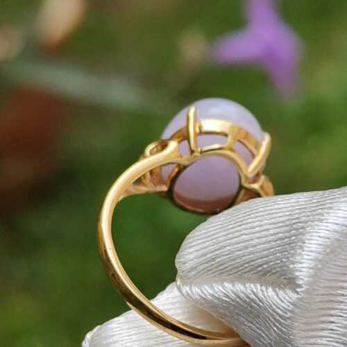 a hand holding a gold ring