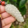 a hand holding a white bead