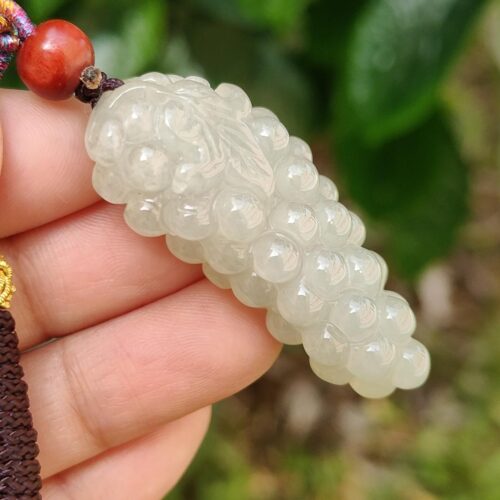 a hand holding a white bead