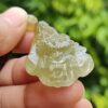 a hand holding a jade dragon head