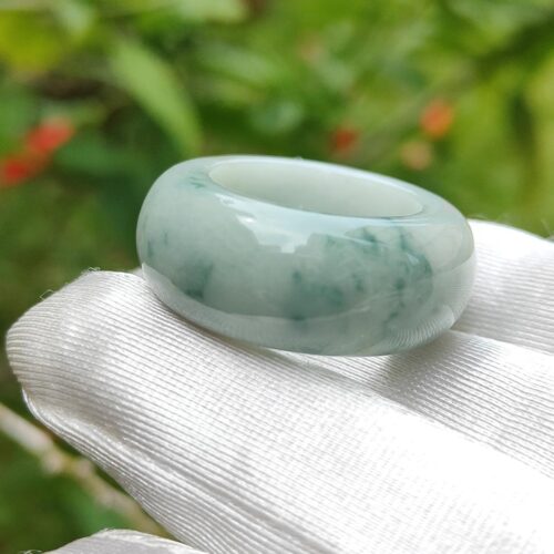 light green with green - a hand holding a ring