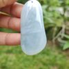 a hand holding a white stone