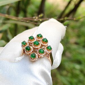 a hand wearing a glove with a ring on it