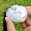 a hand holding a white stone