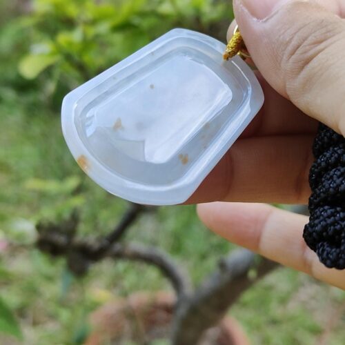 a hand holding a plastic container