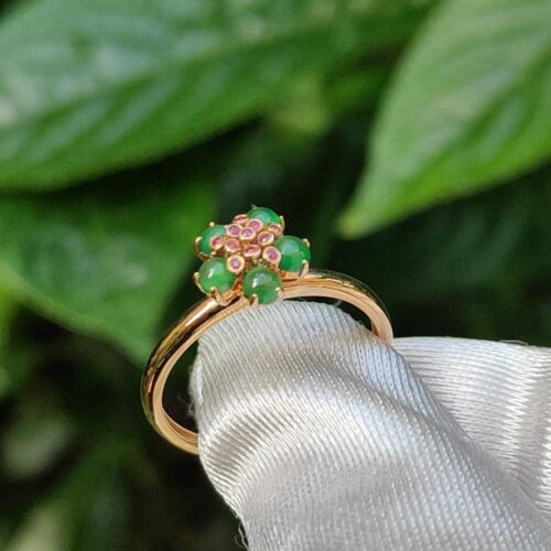 a ring with green stones on it