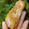 a hand holding a carved stone