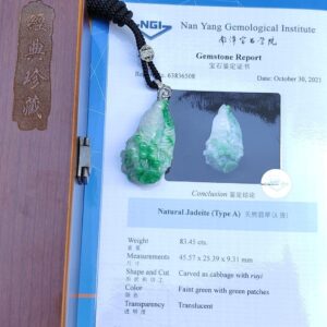 a green jade pendant on a black cord