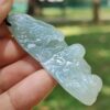 a hand holding a blue stone
