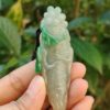 Una mano sosteniendo un colgante de jade.