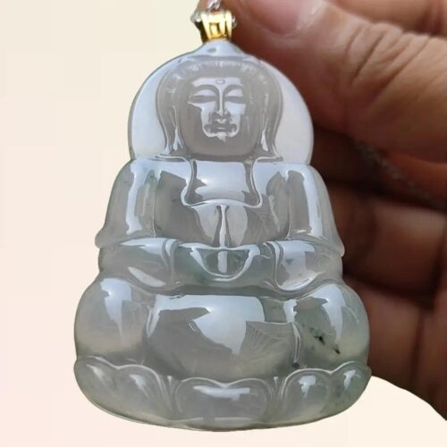 a hand holding a jade pendant