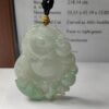 a jade pendant on a table