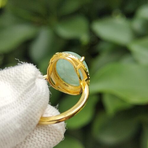 a hand holding a gold ring