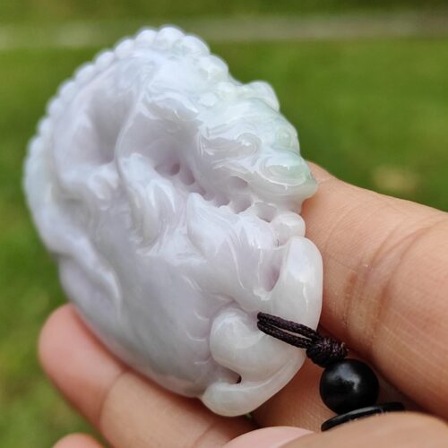 a hand holding a white stone