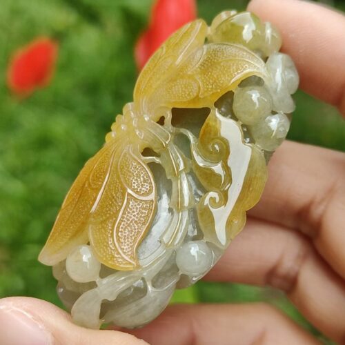 a hand holding a carved stone