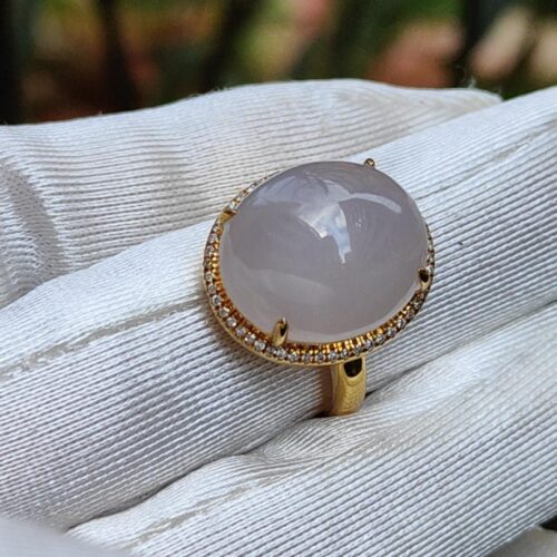 a hand wearing a gloved hand with a ring