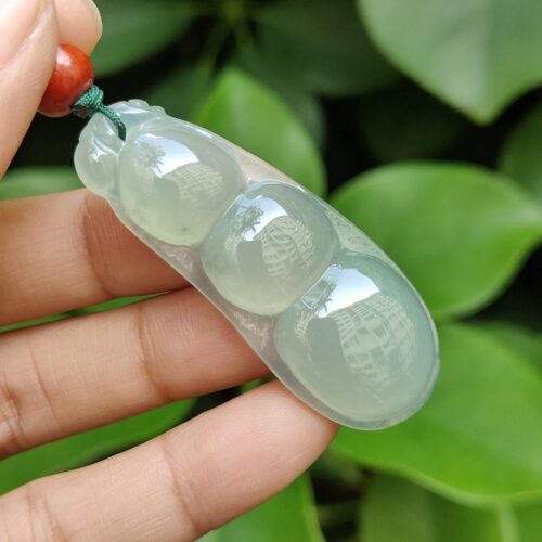 a hand holding a necklace