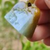 a hand holding a piece of jade