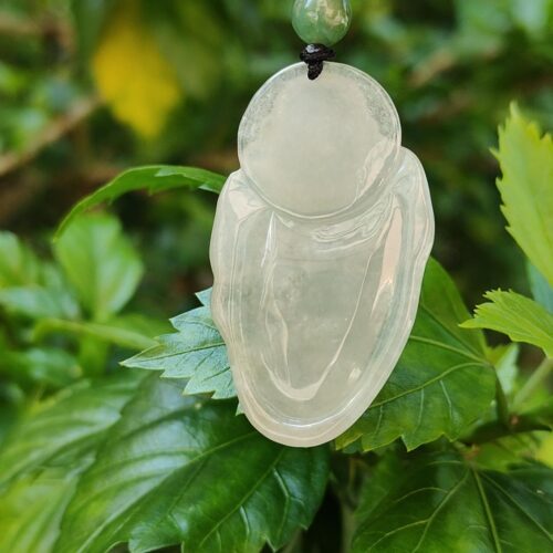 a jade pendant on a plant