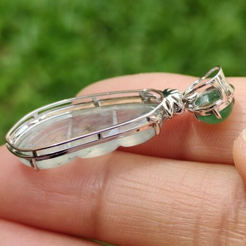 a hand holding a pendant