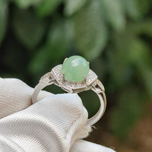 a ring with a green stone on it