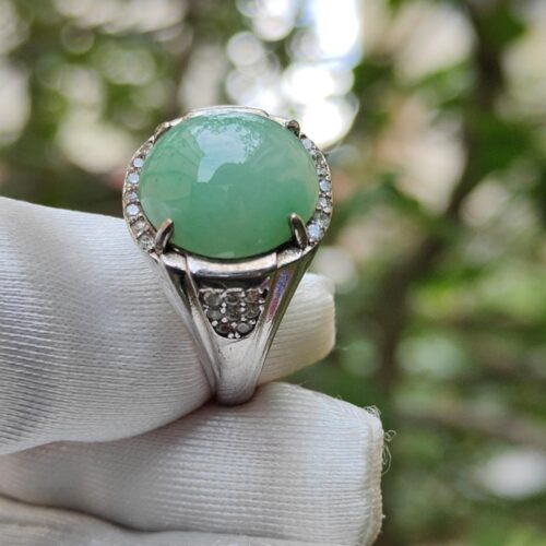 a ring with a green stone in the middle