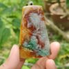 a hand holding a piece of stone
