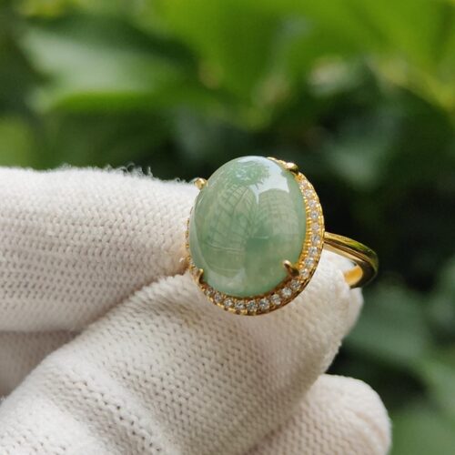 a hand wearing a glove with a ring