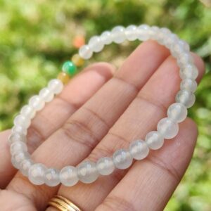 a hand holding a bracelet