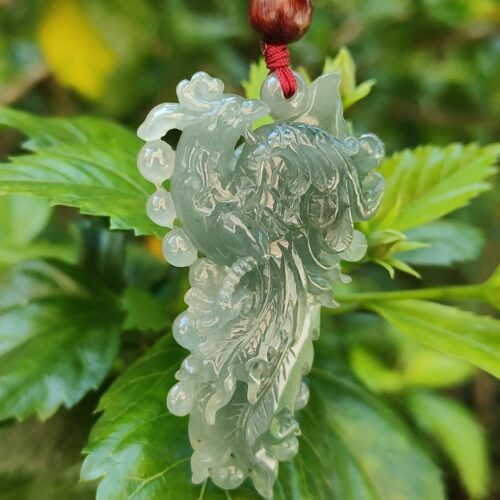 a jade pendant on a plant