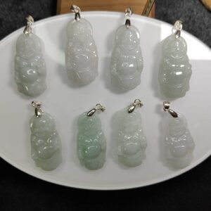 a group of jade pendants on a white plate
