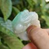 a person holding a jade ring