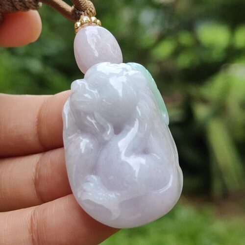 a hand holding a pendant