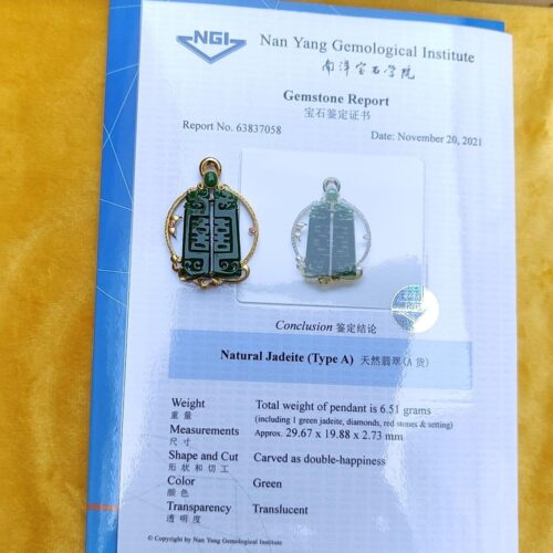 a pair of jade earrings on a piece of paper