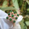 a ring with green stones on it