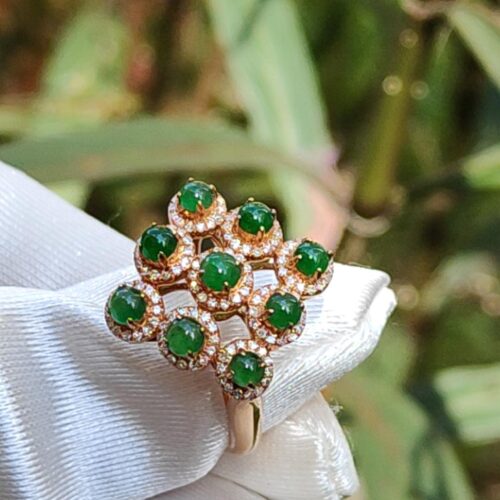 a ring with green stones on it