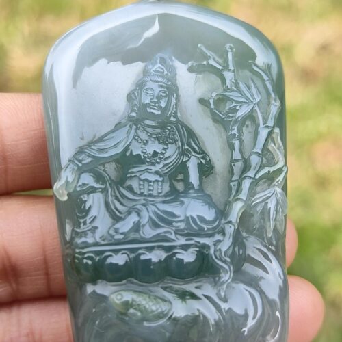 a person holding a jade pendant