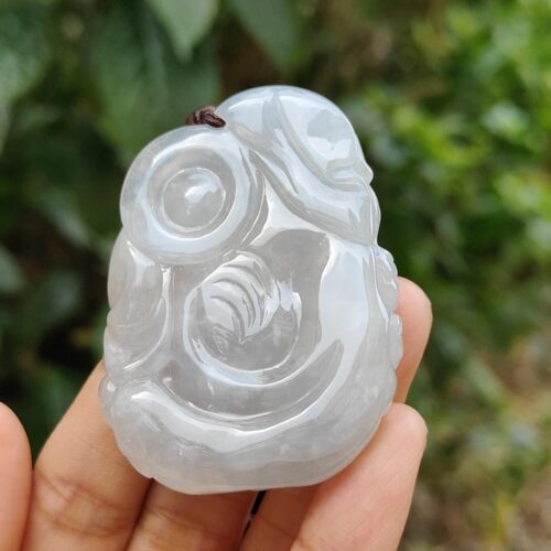 a hand holding a white stone